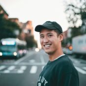 man stranding on straight road photo during daytime